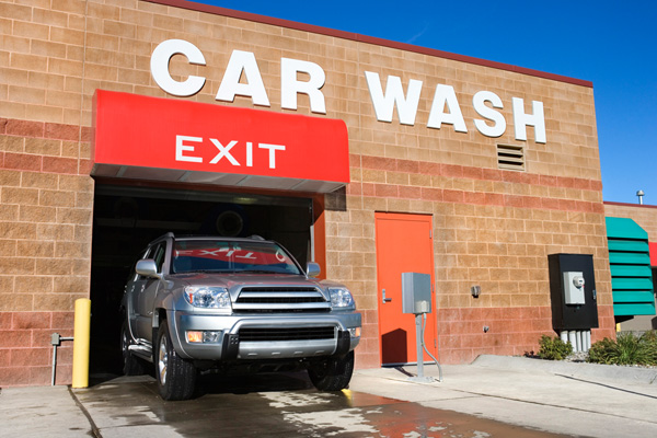 A photo of a car existing a car wash building, a business that would benefit from commercial property insurance