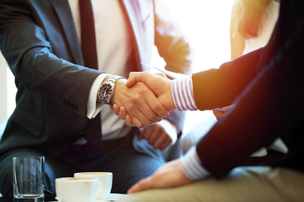 A photo of a handshake - Links to Group Life Insurance page
