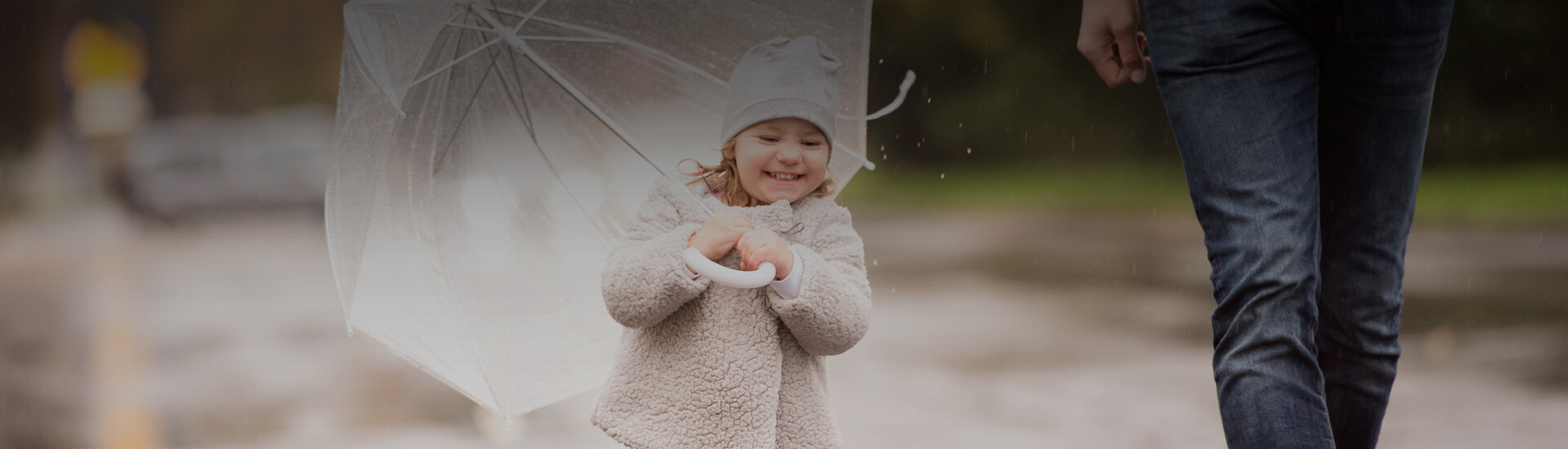 Photo of a baby smiling with her umbrella