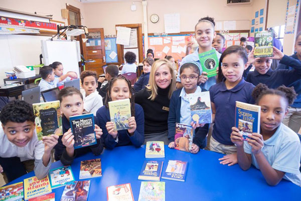 Photo of children holding books to read at Link to Libraries
